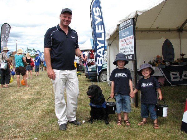 The fundraising Barnett boys, from left: Dad John with sons James and Daniel, joined by guide dog Macey at the Warkworth A & P show.